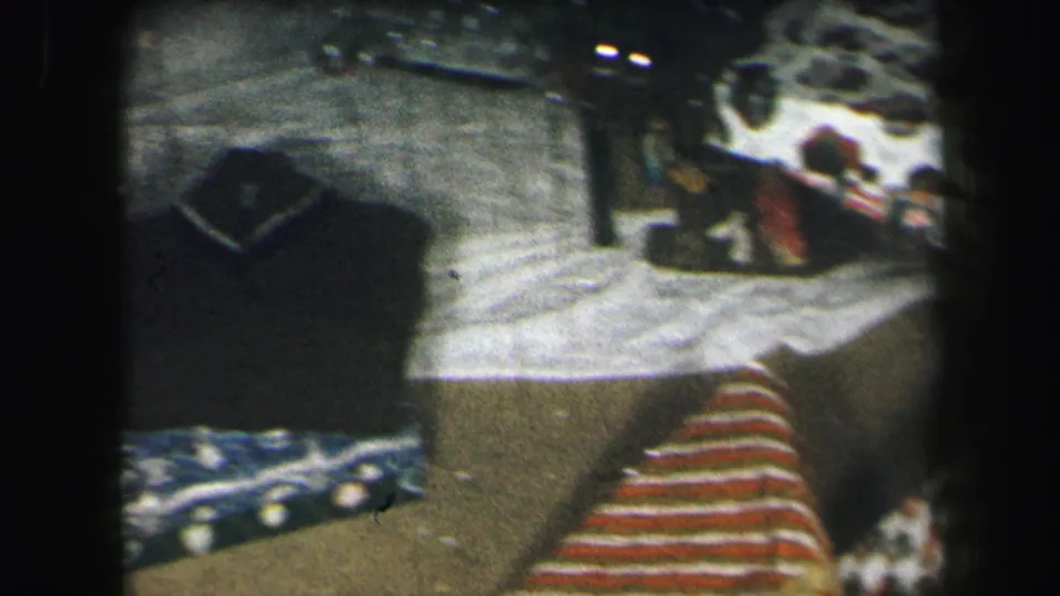 1971 Lynbrook frame showing wrapped Christmas presents and toys from a slightly shifted handheld angle.