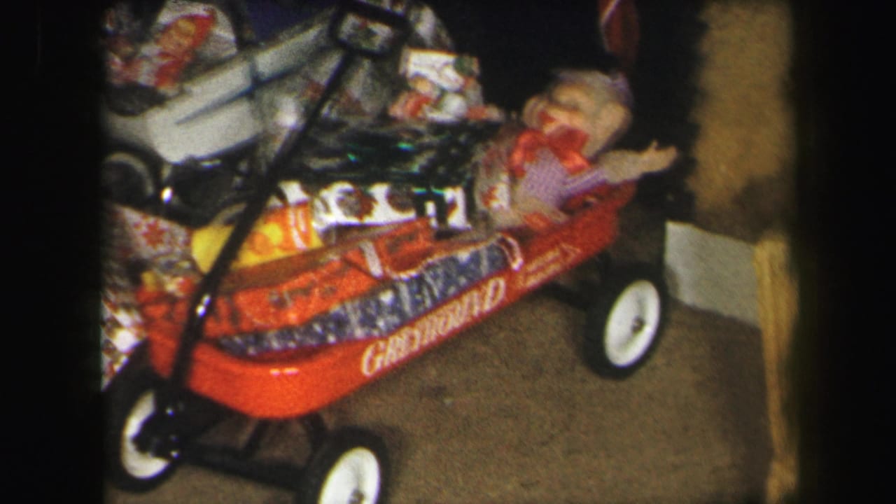Red wagon with gift boxes and a plush monkey doll near its front edge.