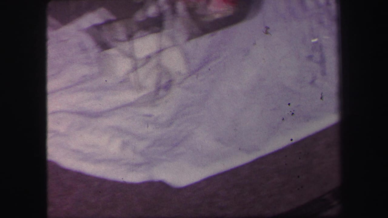 White cloth or tree skirt beside a curved toy train track.