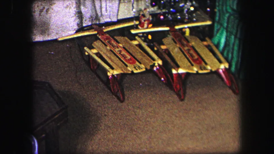 Two classic wooden sleds with red metal runners are shown close to the Christmas tree in the 1971 Lynbrook interior.