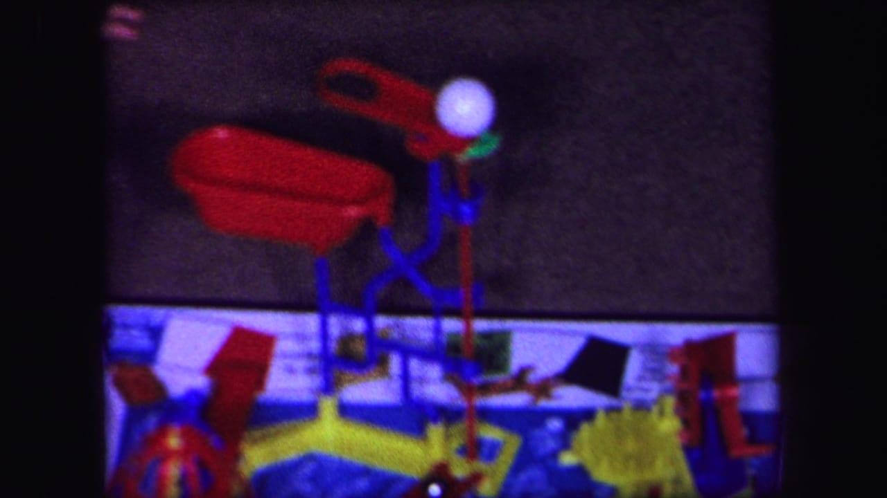 White ball near red and blue plastic pieces above the printed game board.