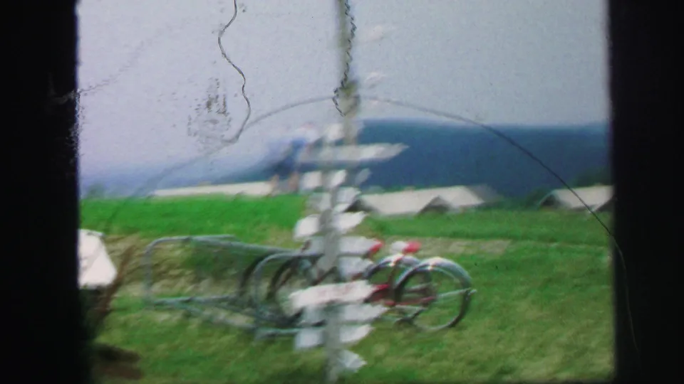 Soft 8mm view of bicycles and a white post structure near the resort lawn in Lynbrook, New York.