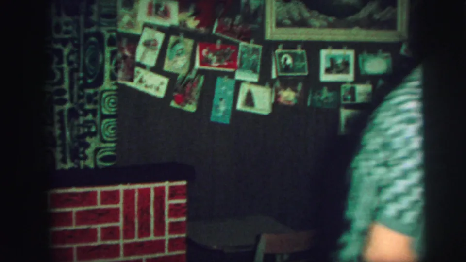 The final frame shows pinned postcards, a framed picture, a red fake fireplace, and a partially visible person in a 1973 Lynbrook room.