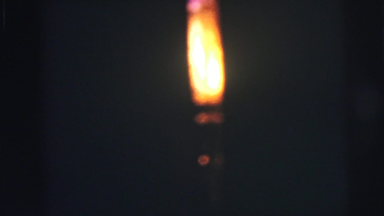 Yellow-orange light glows in a mostly black frame.