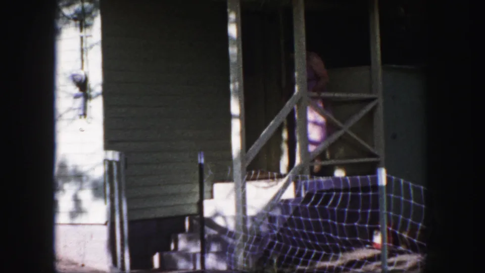 At the end of the 1958 porch scene, the woman is mostly inside the doorway while the exterior railing and siding stay in view.