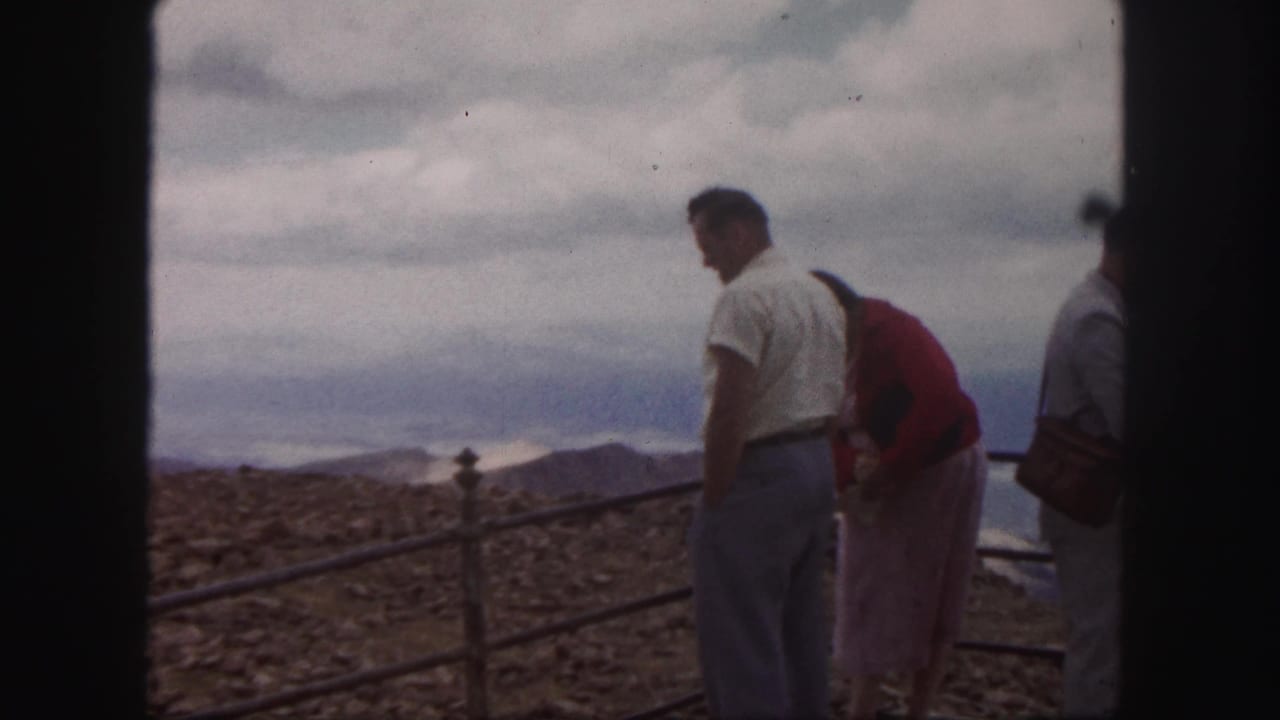 Adult visitors at a Colorado Springs mountain overlook, filmed on 8mm in 1958 with soft color and visible grain.