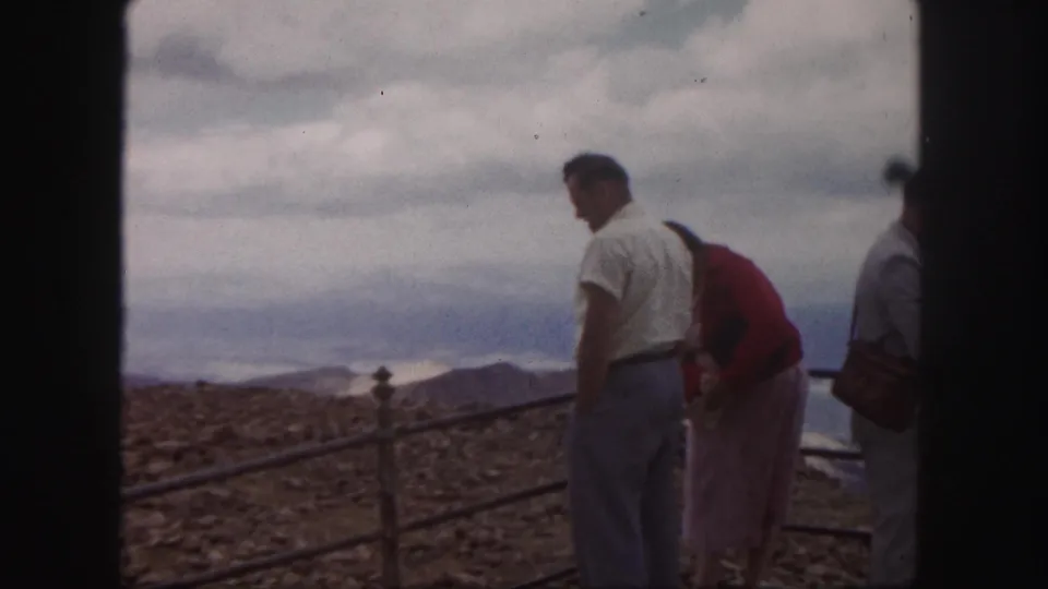 Adult visitors at a Colorado Springs mountain overlook, filmed on 8mm in 1958 with soft color and visible grain.