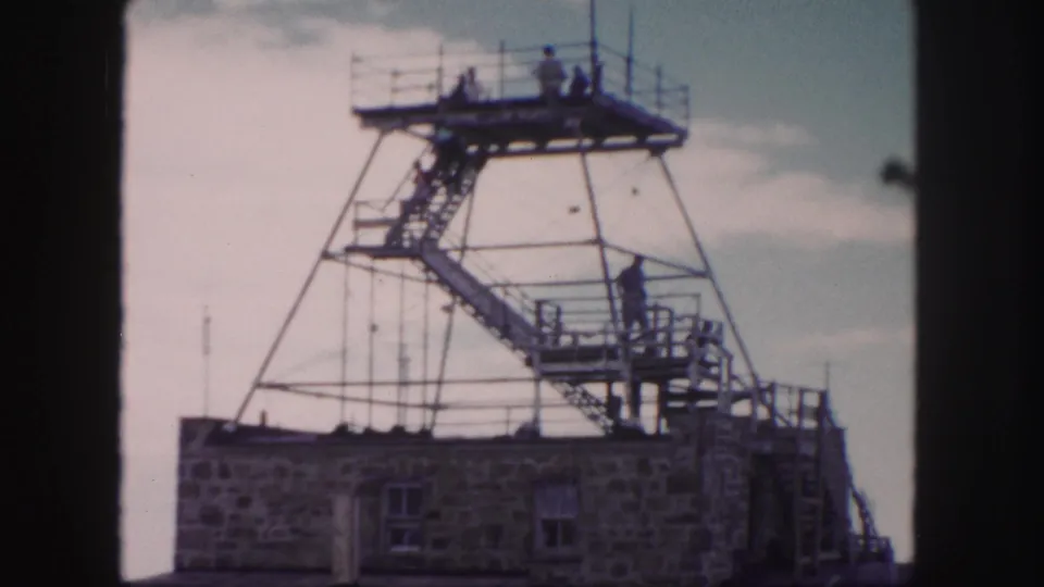 Colorado Springs 1958 home-movie view of a person on the tower stairway with more visitors on the top platform.