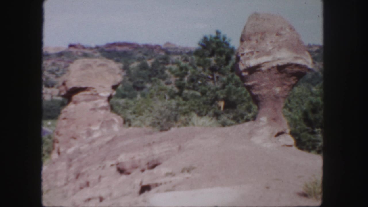 Rock formations and trees viewed from a similar angle in bright daylight.