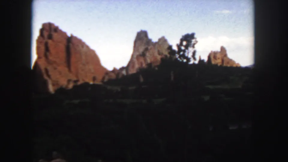 The final frame shows Colorado sandstone formations, scattered trees, and dark foreground brush in 1958 8mm footage.