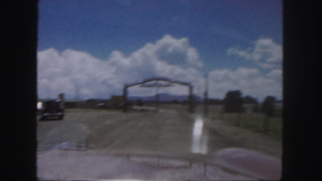 1958 Colorado 8mm view from inside a car approaching the Royal Gorge Scenic Railway entrance on a dirt road.