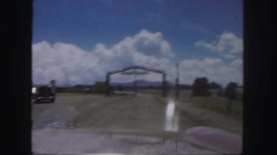 1958 Colorado 8mm view from inside a car approaching the Royal Gorge Scenic Railway entrance on a dirt road.