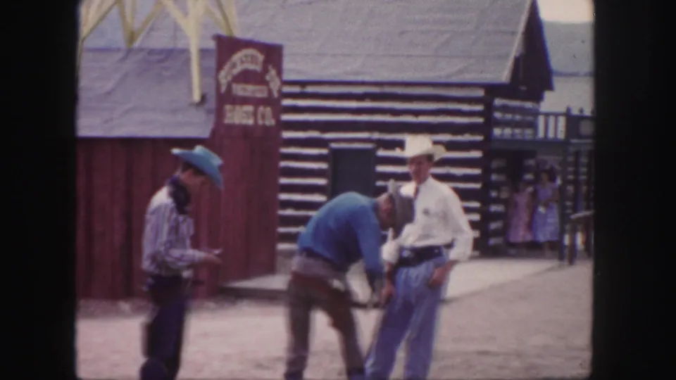 Three men in cowboy-style clothing stand near the Horse Co. sign and log-front building in 1958 Colorado footage.