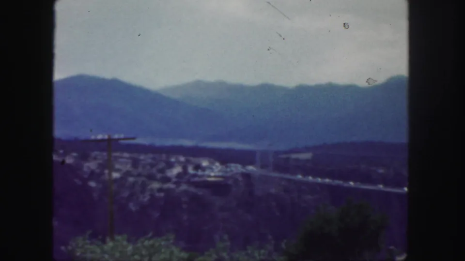 Colorado mountain panorama with a bridge crossing a valley, filmed from an elevated roadside viewpoint.
