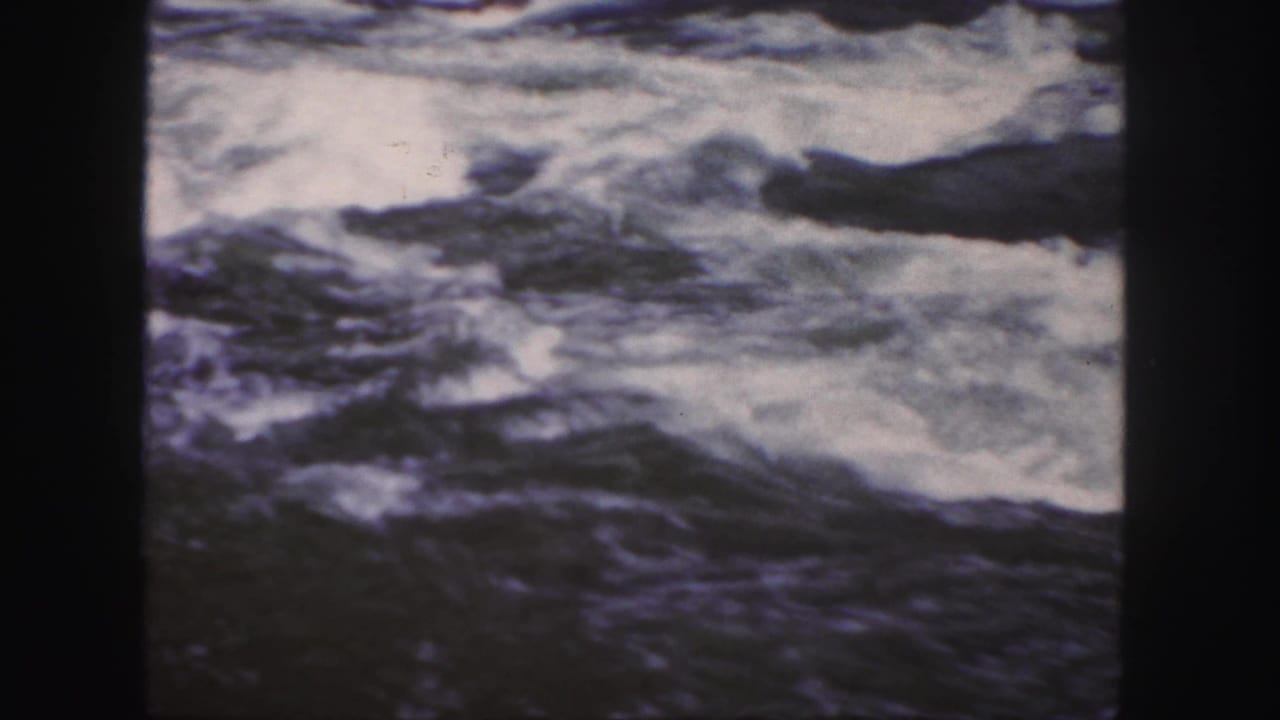 Close view of churning river water with white foam and dark currents.