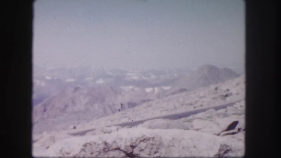 Wide hazy mountain landscape in Colorado, supported by supplied 1958 8mm home-movie metadata.