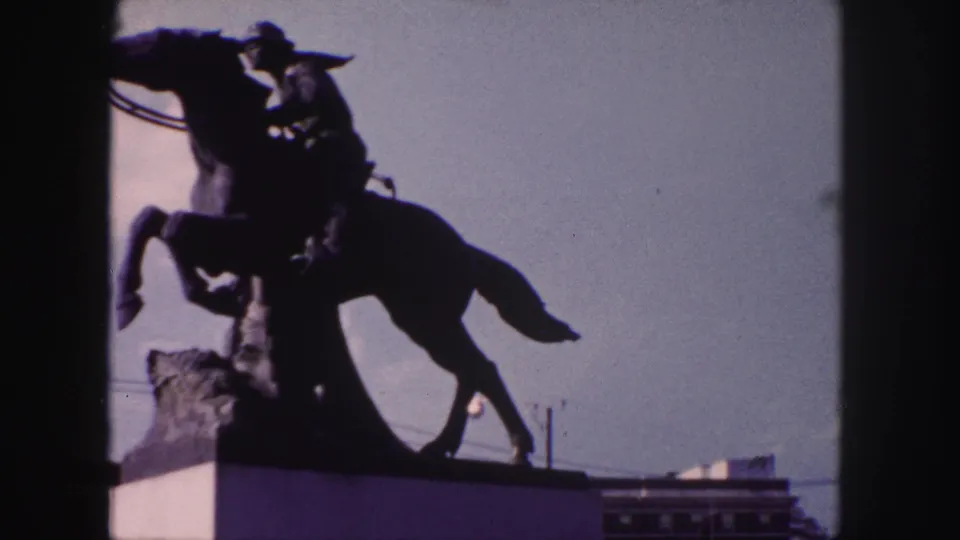 The final frame holds on the Denver Pony Express statue, with the rider and raised horse silhouetted against open sky.