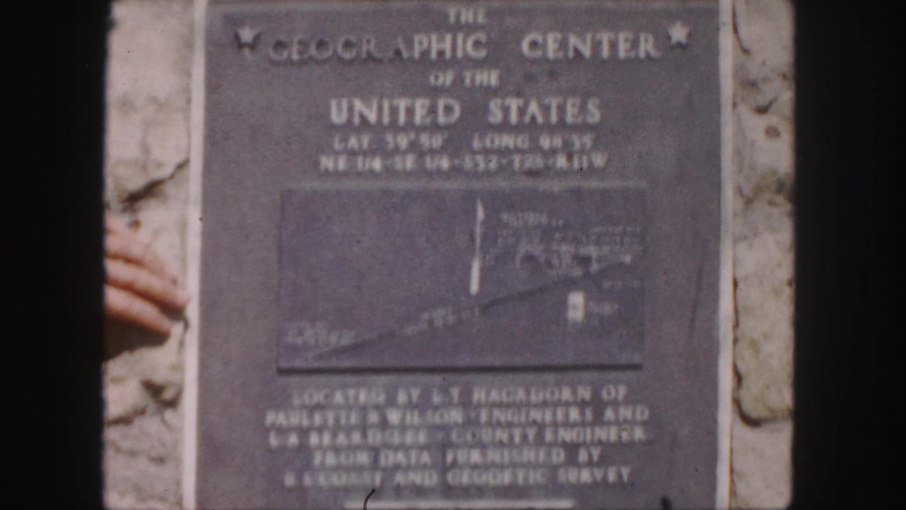 Close view of the same Geographic Center plaque with engraved text and map inset.