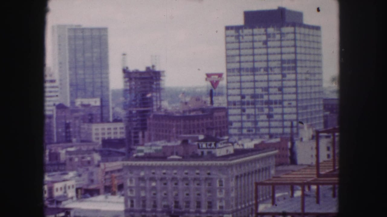Elevated downtown skyline with high-rises, construction, and a YMCA sign.