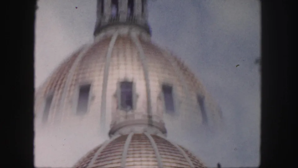 Blurred 1958 Denver home-movie frame showing the dome and upper lantern as the camera moves upward.