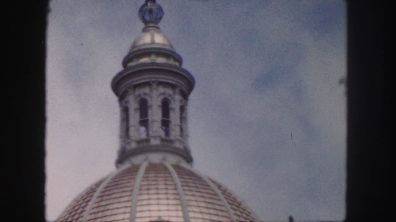 1958 Denver 8mm frame showing the upper lantern and arched openings above a tiled architectural dome.