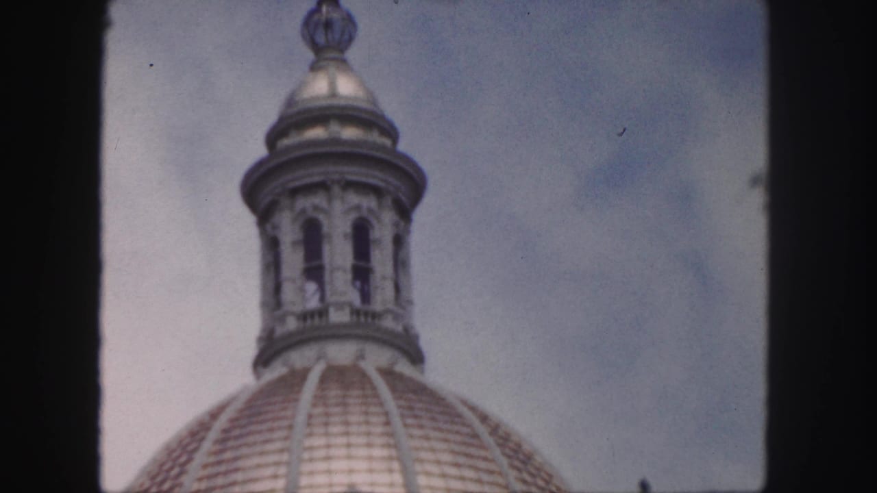 Similar close view of the dome lantern and upper roof framed by film borders.