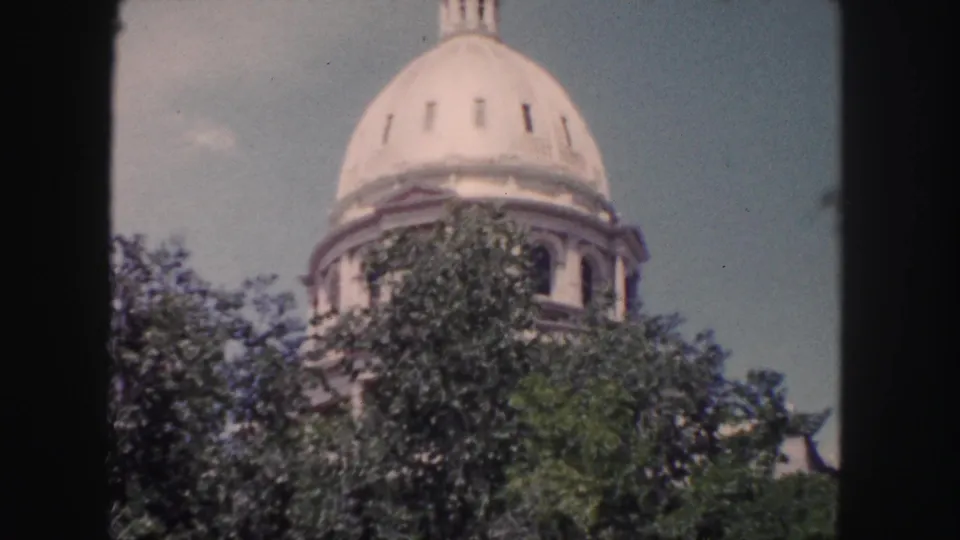 1958 Denver footage holds on the capitol dome, with foliage covering the lower rotunda.