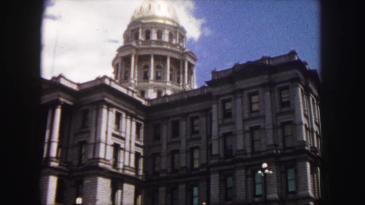 Colorado State Capitol dome and upper facade framed by dark film edges.