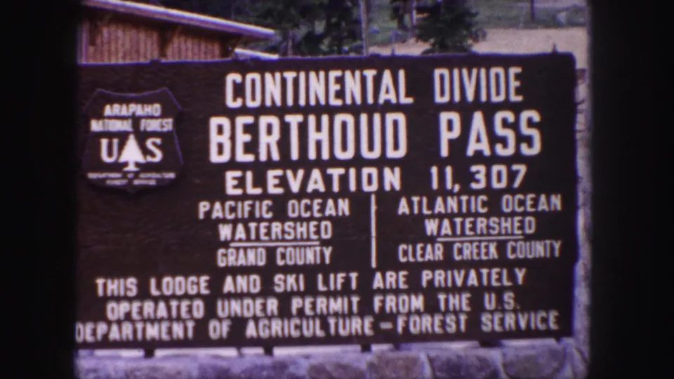 1958 Colorado frame of the Berthoud Pass Continental Divide sign, filmed close enough for most lettering to be read.