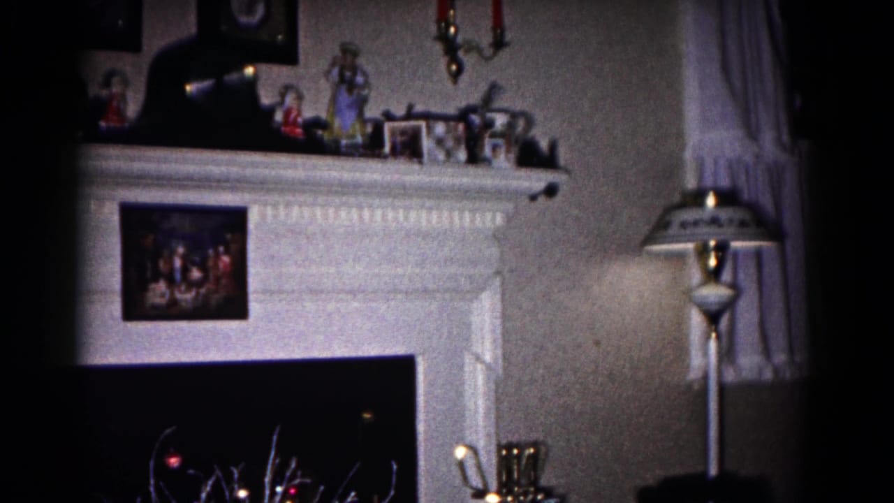 1958 Hagerstown living room view with a decorated fireplace mantel, floor lamp, and sheer curtains.