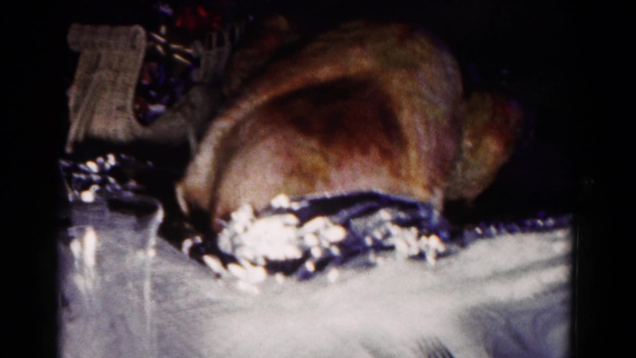 1958 Hagerstown frame with a roasted turkey dominating the table, with a decorative basket and dark interior background visible behind it.