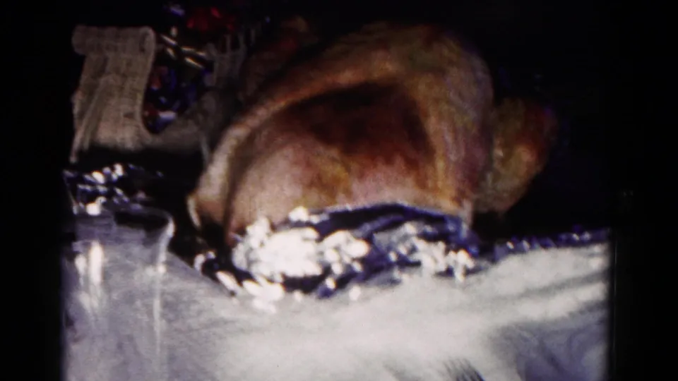 1958 Hagerstown frame with a roasted turkey dominating the table, with a decorative basket and dark interior background visible behind it.