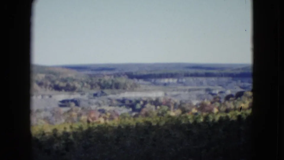 Soft 1958 8mm view across a broad valley and distant horizon, framed by dark edges in the Las Vegas-labeled clip.