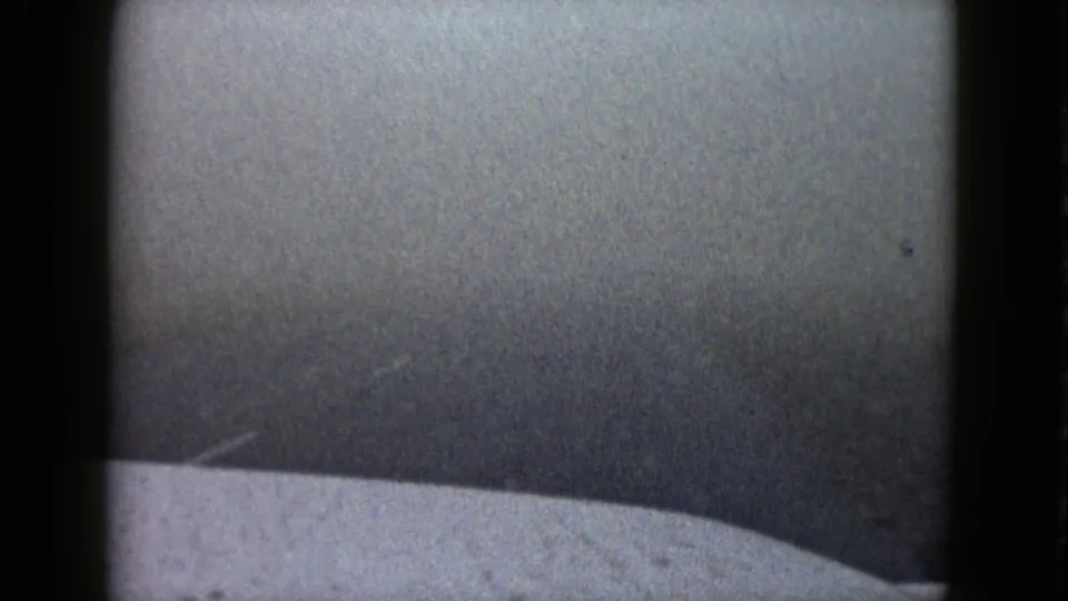1958 Las Vegas frame showing a soft, grainy vehicle-view scene with haze, dark borders, and little identifiable detail.