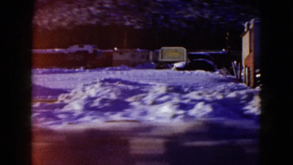 Final frame shifts to a dark snowy roadside scene with vehicles and illuminated shapes, likely separate from the desert inn sequence.