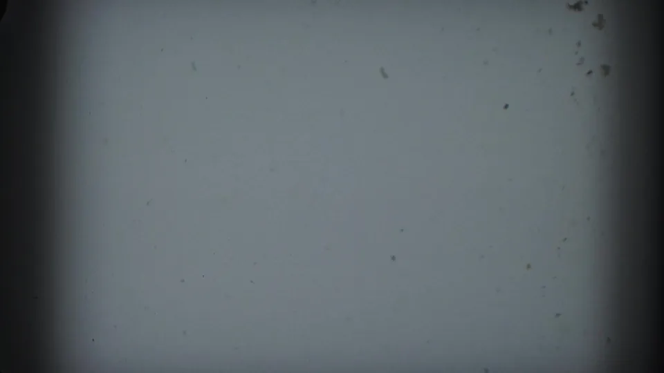 1958 Ontario 8mm home-movie frame showing blank projection texture, dark edge shading, dust, and a horizontal splice-like band.