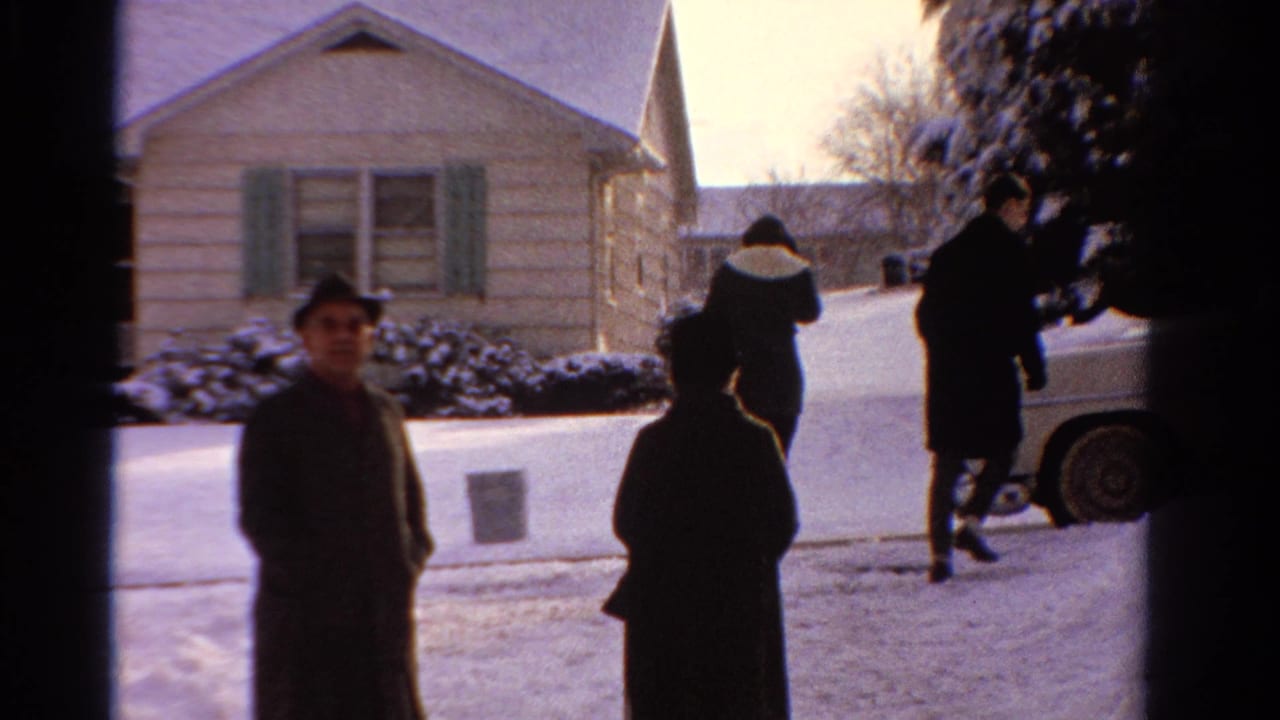 1958 Ontario winter scene with adults in coats outside a suburban home, viewed through a dark doorway or window frame.