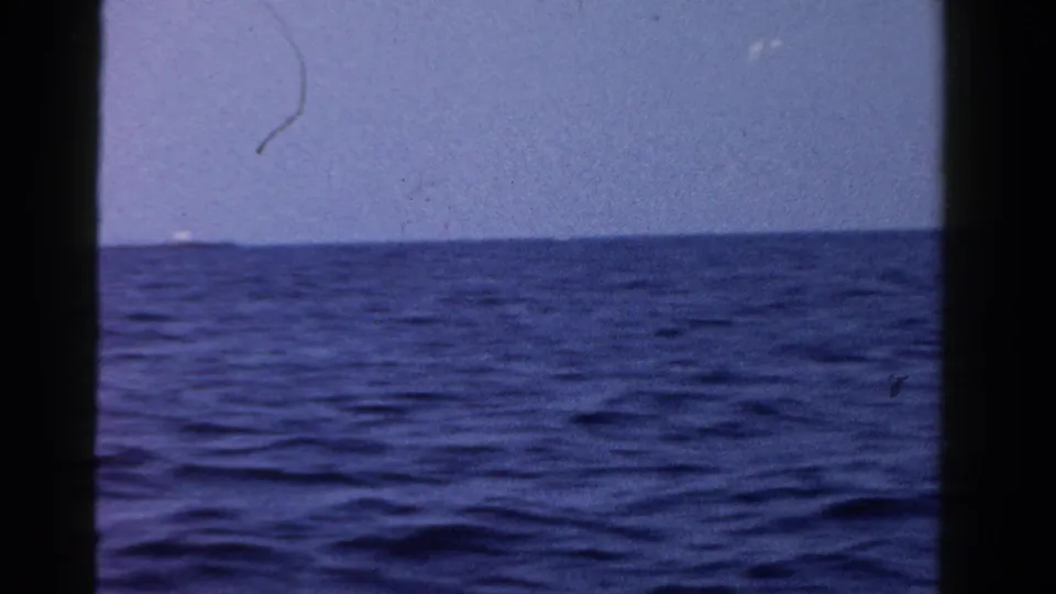 1958 8mm home-movie frame showing open Ontario water, a low horizon, and visible film borders.