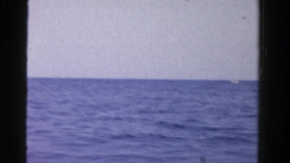 A 1958 Ontario vessel-view frame shows blue water, pale sky, and a dark central film or gate band.