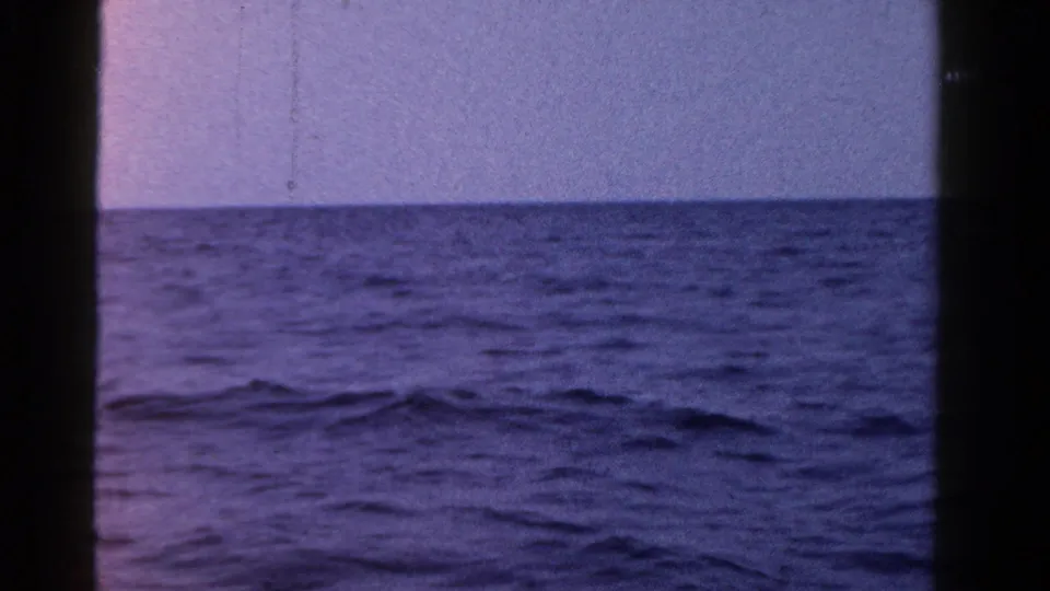 1958 Ontario home-movie frame of open water and a flat horizon, with no visible people or boats nearby.