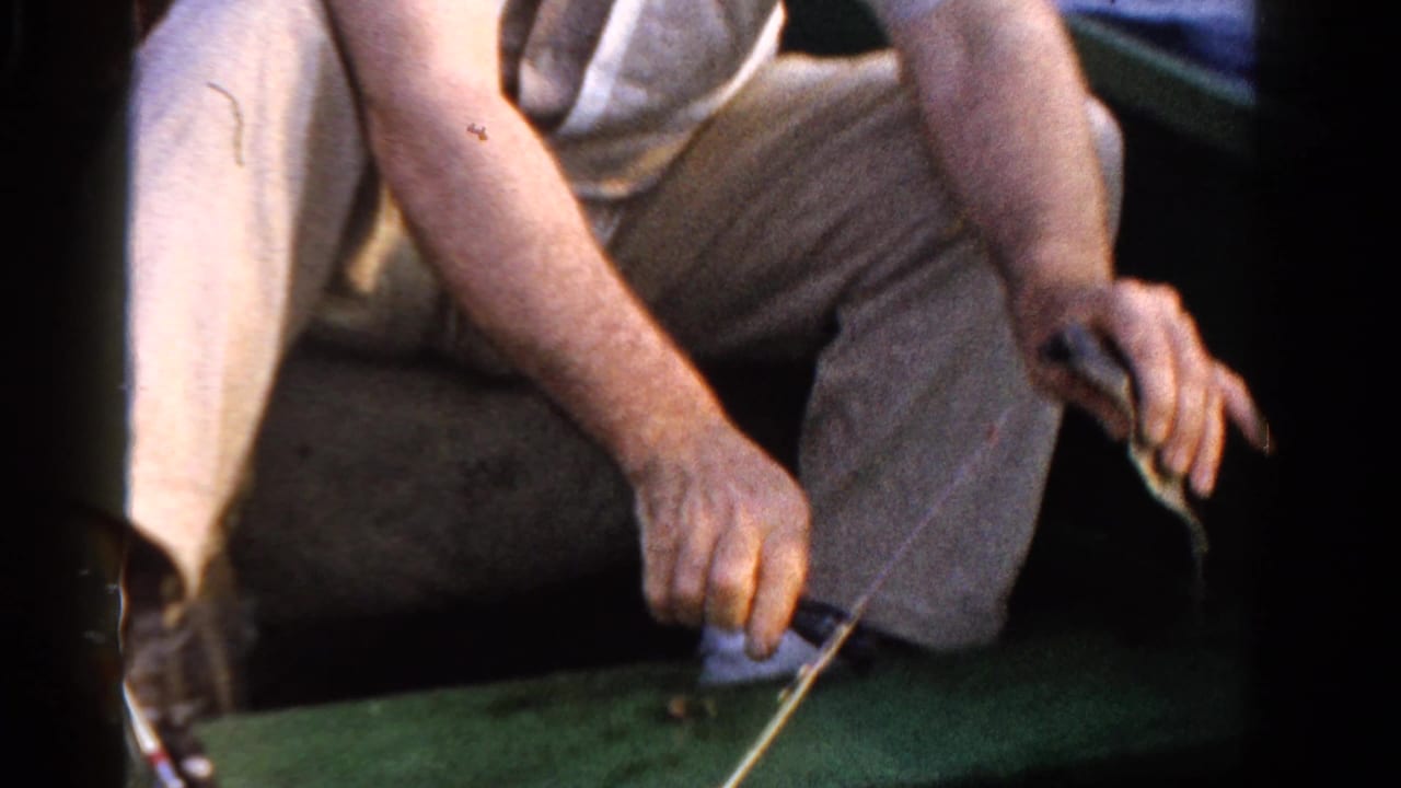 A close 8mm view from the boat shows seated adults and fishing line over the boat edge in Ontario, Canada.