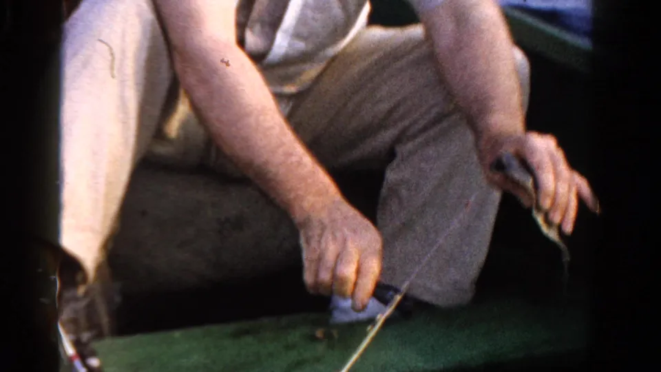 A close 8mm view from the boat shows seated adults and fishing line over the boat edge in Ontario, Canada.