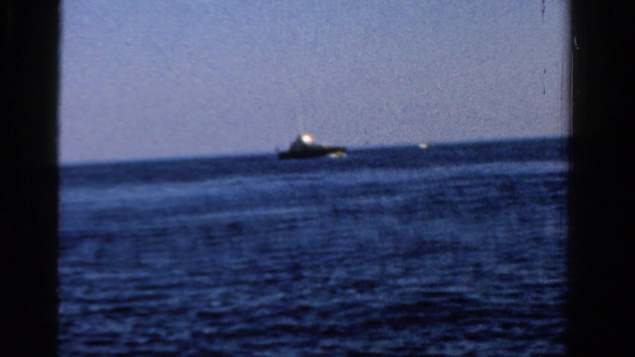 Open lake water with a distant boat near the horizon under a clear sky.