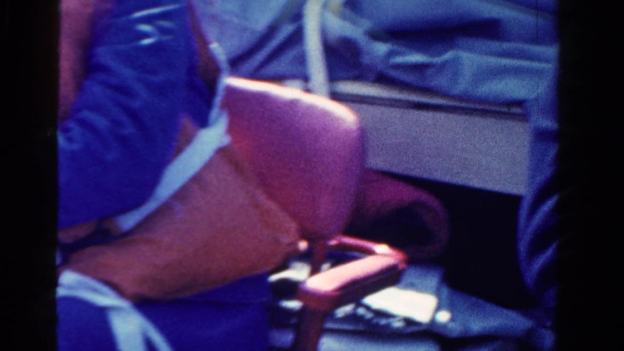 Close 8mm frame shows a red life vest, blue clothing, and boat seating during the Ontario boating scene.