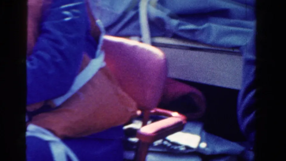 Close 8mm frame shows a red life vest, blue clothing, and boat seating during the Ontario boating scene.