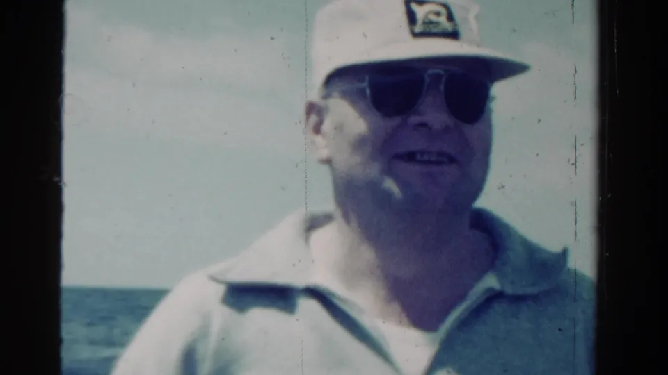 The man turns slightly off-center on the boat, with Ontario location and 1958 date supported by clip metadata.