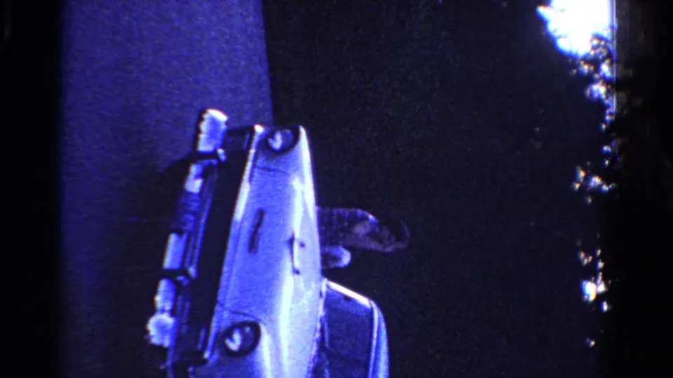 The final frame centers the pale mid-century car, with the woman partly obscured beside it under dark blue nighttime lighting.