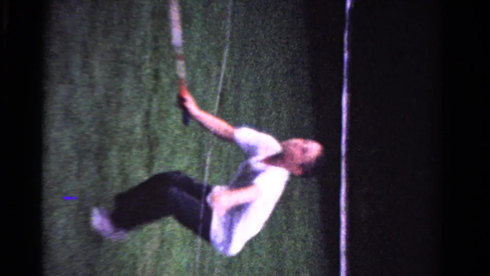 The second player swings a racket on the grass court during the 1958 Ontario family tennis rally.
