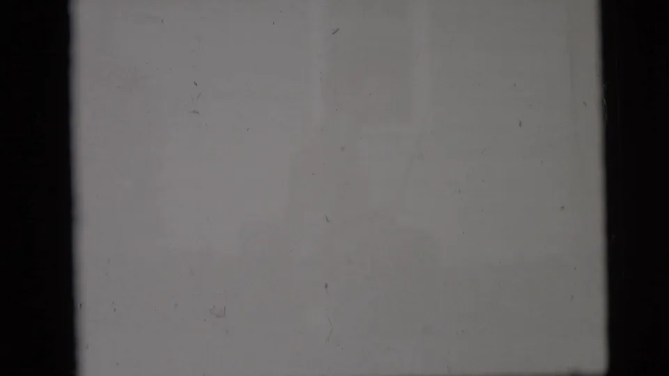 The final contact-sheet cell is largely blank or overexposed gray film, with dust specks and dark frame edges visible.