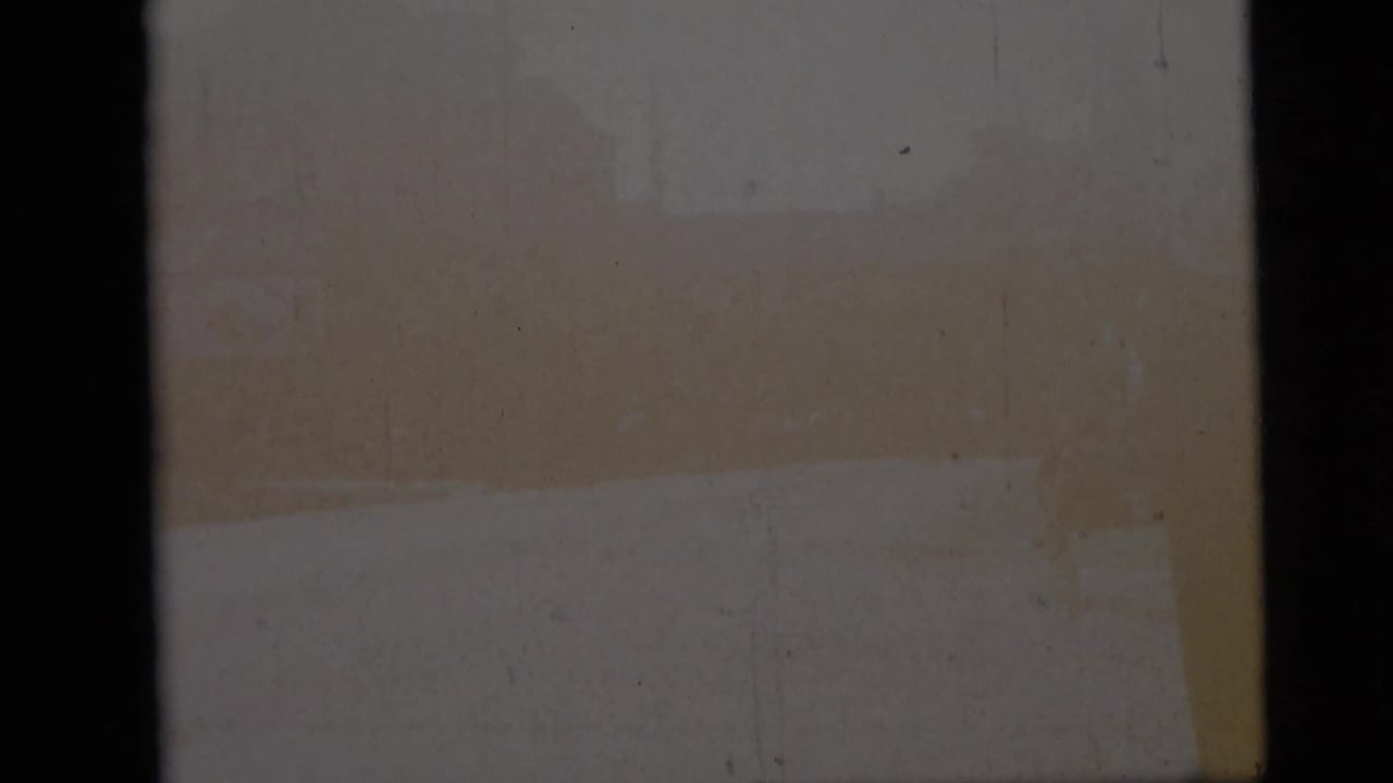 Start frame from a 1959 8mm Camden street clip, partly obscured by film edge or exposure with little street detail visible.